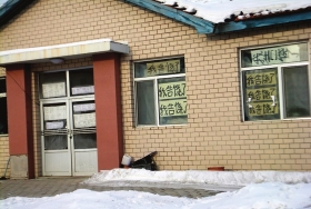 伊春市帶嶺區(qū)一排破舊的平房，房間窗戶上貼滿了“我告饒了”的字樣。