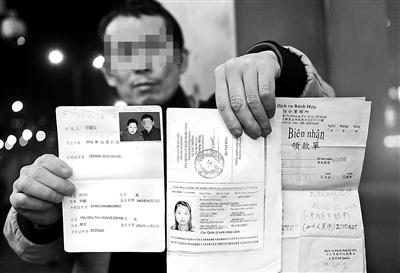 賀先生向記者出示他與越南妻子的結(jié)婚證、新娘護(hù)照和部分相關(guān)交費(fèi)單據(jù) 攝影/本報(bào)記者　袁藝