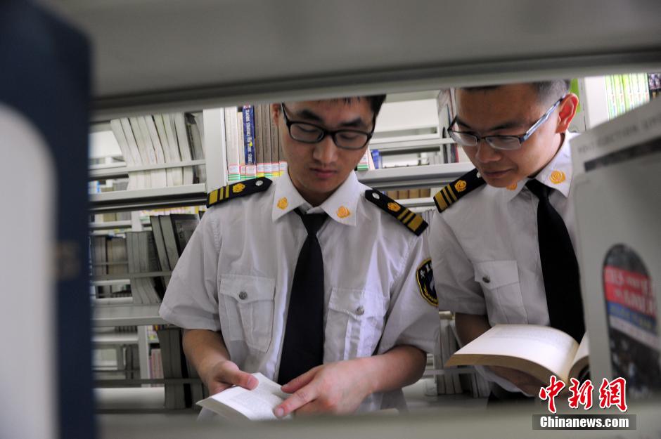 5月8日，武漢輕工大學(xué)圖書館保安吳濤與江力在圖書館交流學(xué)習(xí)。